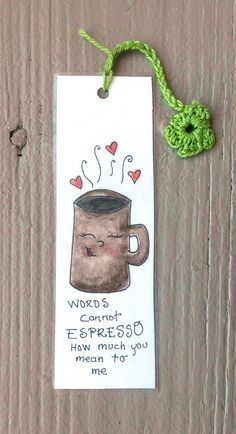 a bookmark with an image of a coffee cup on it and a green string attached to it