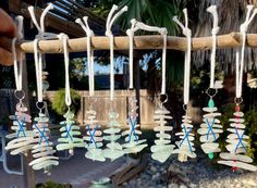 several wind chimes hanging from a tree branch