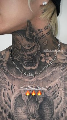 the back of a woman's neck with an owl and demon tattoo on it