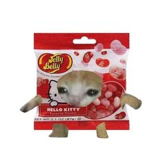 a small stuffed animal in a package with jelly beans on it's back end