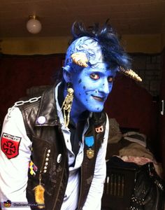 a man with blue makeup and horns on his head