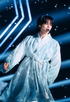 a woman in a white kimono performing on stage