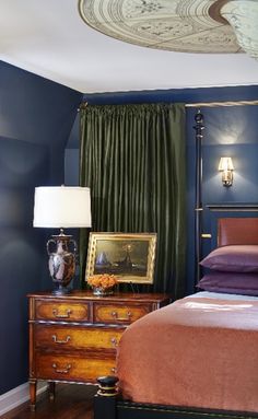 a bedroom with a bed, dresser and lamp in it's centerpieces