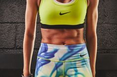 a close up of a person wearing a sports bra top and shorts with nike logo on it