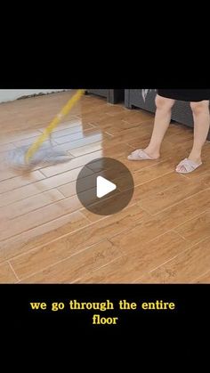 a woman is cleaning the floor with a mop