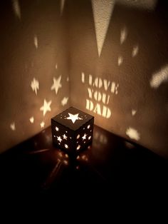 a light that is sitting on top of a table with stars projected from it's shadow