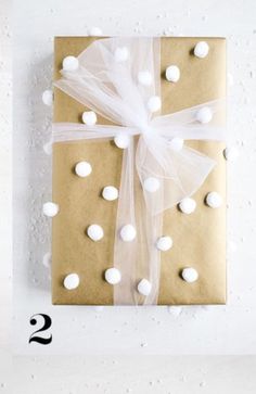 a present wrapped in brown paper with white polka dots