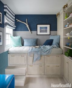 an instagram photo of a bedroom with blue walls and white cabinets, built in bookshelves