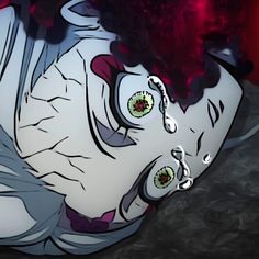 an animated image of a creepy clown with green eyes and purple hair, laying on the ground