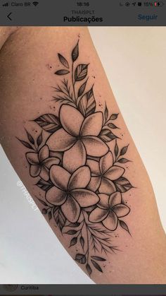 a black and white flower tattoo on the arm