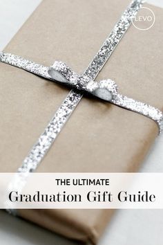 a gift wrapped in brown paper with the words the ultimate graduation gift guide on it