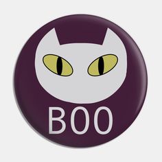 a button with an image of a cat's face and the words boo on it