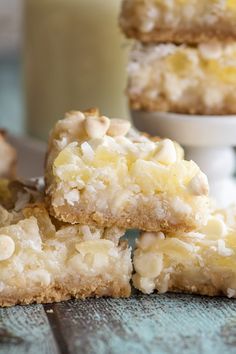 three pieces of cake sitting on top of a table next to a glass of milk