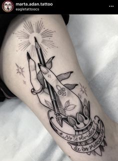 a woman's leg with a tattoo on it and scissors in the middle of her leg