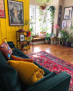 a living room filled with furniture and lots of plants