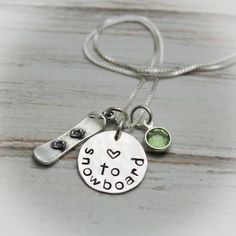 a necklace with two charms on it that says, i love you to the moon and back