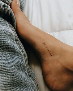 a person's foot with the word love written on it in cursive writing