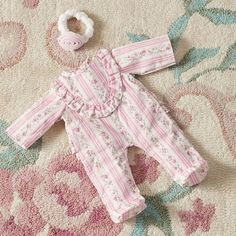 Little ones will love getting their baby doll ready for naptime and bedtime with this one-piece pajama. Woven of durable cotton, its printed with a meadow's worth of blooms and detailed with ruffles. Plus, it includes a matching rosette headband for a stylish finishing touch. Designed exclusively for Pottery Barn Kids by lifestyle brand LoveShackFancy. DETAILS THAT MATTER Nightgown is made of cotton percale with a printed design. Headband is made of elastic and softboa. Sleeves feature ruffles on cuffs. KEY PRODUCT POINTS Pottery Barn Kids exclusive. Spot clean. Imported. Bloomer Pajama Set, Loveshackfancy Pajamas, Toddler Bed Pottery Barn Kids, Pottery Barn Baby, Dollhouse Nursery Pottery Barn Kids, Vintage Baby Doll Pajamas, Rosette Headband, Pajama Outfit, Crib Bumper