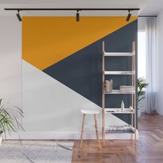 an abstract wall mural with yellow, grey and white triangles