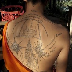 the back of a man's upper body covered in writing