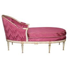 a pink chaise lounge with gold trimming