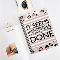 an open notebook with the words it seems impossible until he's done