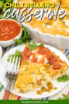 a white plate topped with a slice of mexican casserole next to a bowl of salsa