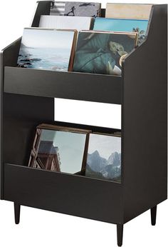 a black book shelf with pictures and photos on it's bottom shelf, against a white background