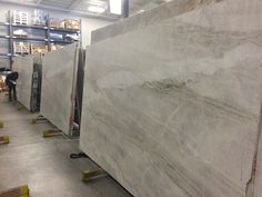 large marble slabs are lined up in a warehouse