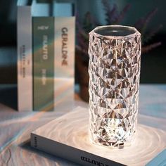 a crystal vase sitting on top of a book