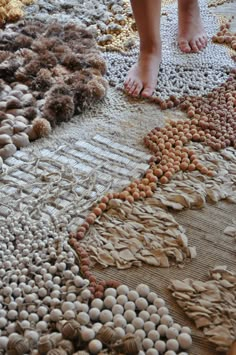 a person standing on top of a rug covered in eggs