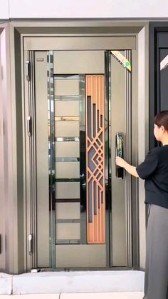 a woman is opening the door to an elevator