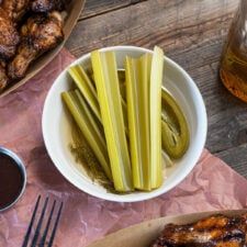 some food is sitting on a table with utensils and sauces next to it