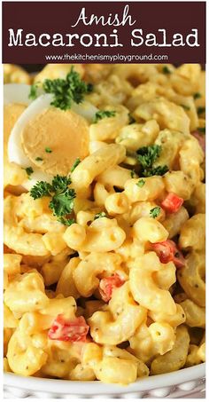 an image of macaroni salad in a white bowl with parsley on top