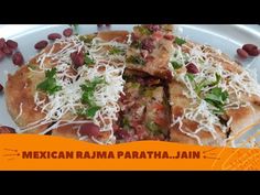 mexican food with beans and cheese is on a white plate next to an orange border