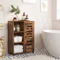 a bathroom with a white bath tub and wooden cabinet