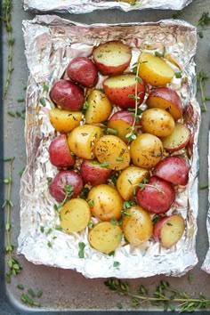 red and yellow potatoes with herbs on tin foil