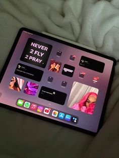 an apple laptop computer sitting on top of a bed covered in white sheets and blankets