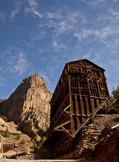 an old wooden structure sitting on top of a mountain