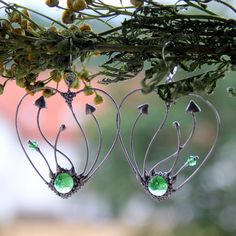 Mushrooms earrings Hearts made from copper wire, tin-copper alloy and green glass. All elements are handmade, which ensures the individuality of each product made in the Yadovito workshop. Polished with a finishing solution to give the jewelry a noble appearance and at the same time so that the metal does not oxidize. The earrings use glass melted in a special furnace. After melting, the glass takes on an almost unique shape and amazing color shades that play in the light. Size about 4.5 cm/4.5 Handmade Metal Fantasy Earrings, Handmade Fantasy Metal Earrings, Whimsical Green Heart-shaped Jewelry, Handmade Green Fantasy Earrings, Whimsical Wire Wrapped Metal Earrings, Bohemian Handmade Sterling Silver Heart Earrings, Handmade Bohemian Sterling Silver Heart Earrings, Mushrooms Earrings, Jewelry Mushroom