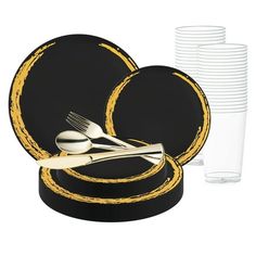 a black and gold dinner set with silverware