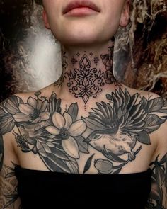 a woman with tattoos on her neck and chest