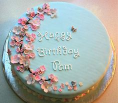 a birthday cake decorated with flowers and the words happy birthday pam on it's frosting