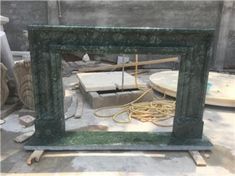 a green frame sitting on top of a wooden floor next to a pile of rubble