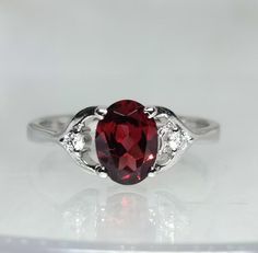 Brand : Walifine Jewellers  Material : 925 Sterling Silver  Gemstone : 100% Natural Garnet  Garnet Stone Weight : 1.20 Carat  Garnet Stone Size : 6×8 MM  Secondary stone : Cubic Zirconia  Cubic zirconia  Stone Weight : 0.04 Carat  Cubic zirconia Stone Size : 2.0 MM Gross weight : 2.3 GM Approx....  Stone Shape : Oval Ring Size : All Size Available  Occasion : For Every Occasion  Benefits of Garnet:- ☆ Garnet is the Stone of Protection and Manifestation. It Protects the Wearer from Negativity and Candy Ring, Red Luxury, Symbol Of Love, January Birthstone, Red Candy, Oval Rings, Garnet Stone, Ring Oval, Rings For Girls