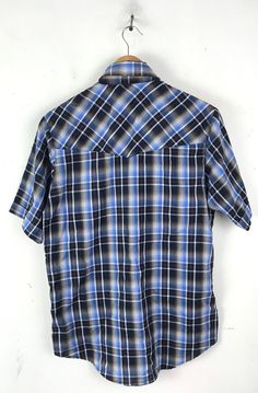 "-Description- >men's blue, black, red, white plaid short sleeve western shirt >collared >snap button front >two snap close pockets on the front >size small/ medium - tag is marked a small but chest measurement is more like a medium, please check all measurements before purchasing >awesome for a cowboy! >condition: great >color(s): blue, black, white, red >fabric(s): 65 polyester / 35 cotton >brand: plains >care: machine wash -Measurements- >size: small/medium Plaid Short Sleeve Camp Shirt With Relaxed Fit, Short Sleeve Plaid Flannel Shirt With Pockets, Plaid Short Sleeve Flannel Shirt With Pockets, Western Collared Summer Tops, Western Style Collared Tops For Summer, Western Collared Tops For Summer, Short Sleeve Cotton Flannel Shirt With Pockets, Western Style Short Sleeve Relaxed Shirt, Western Style Relaxed Fit Short Sleeve Shirt