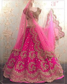 a mannequin is dressed up in a pink and gold lehenga set