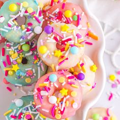 there are many donuts with sprinkles on the plate