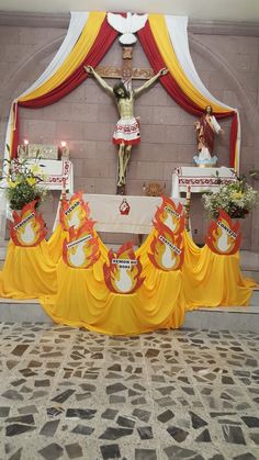 the altar is decorated with yellow cloths and flowers