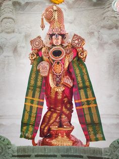 the statue is decorated with gold, red and green colors